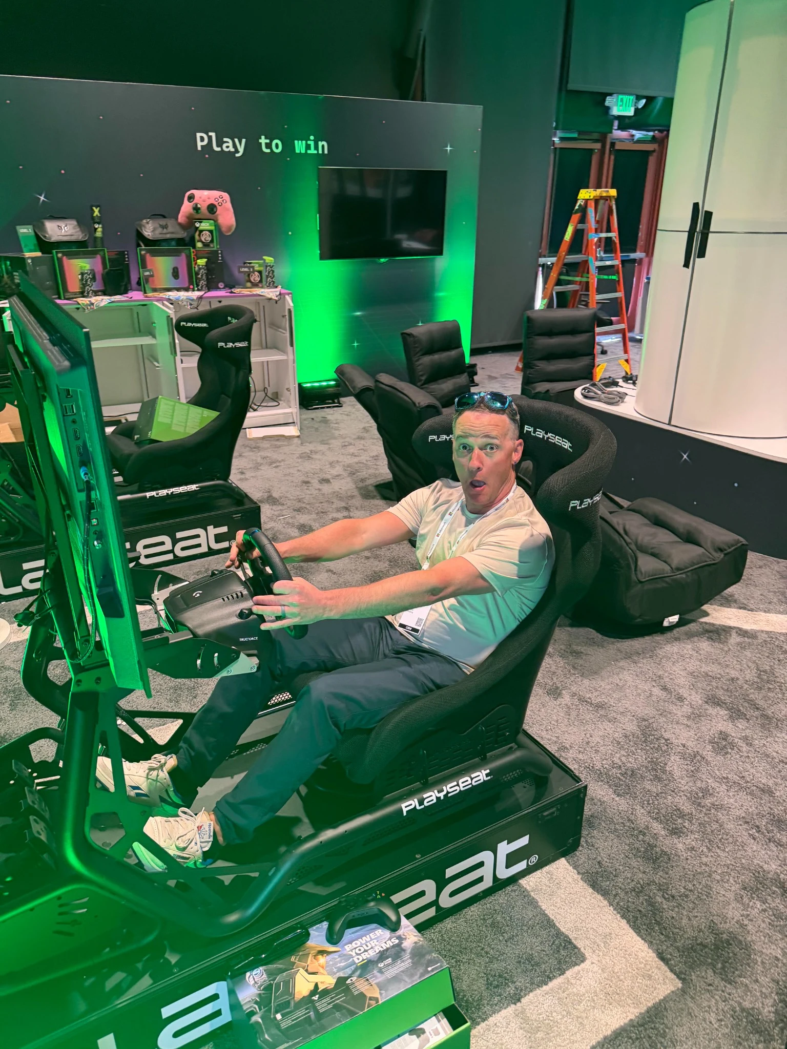 Ty Hagerott seated in an Xbox racing simulator at an event
